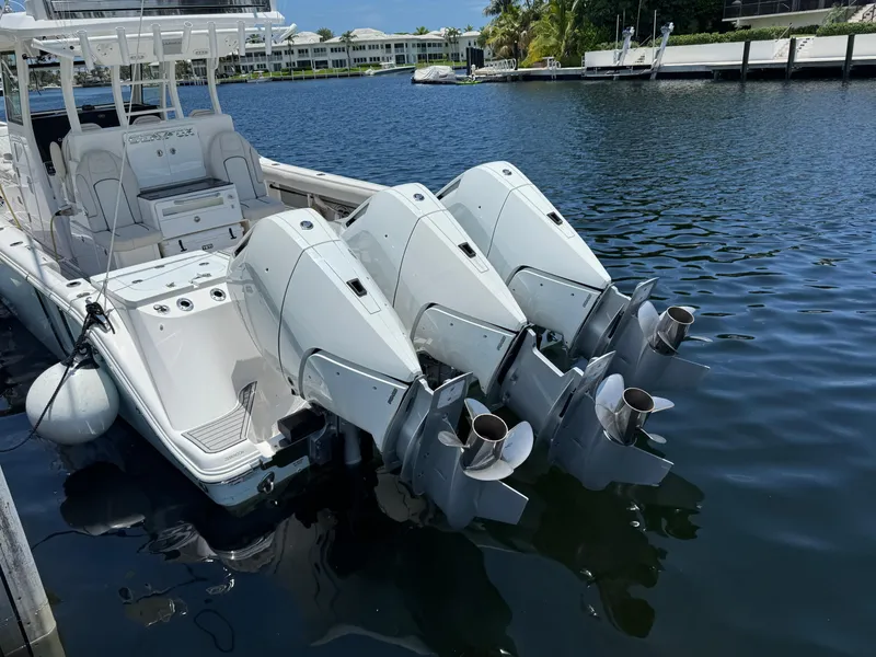 Slide: The Image of 2023 Sea Fox 368 Commander boat interior with seating and console, docked by waterfront homes. - 17