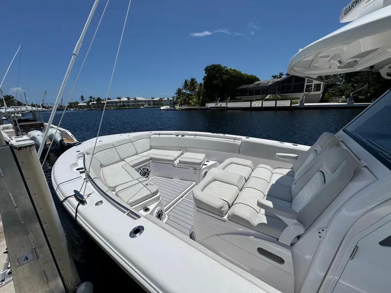 Slide: The Image of 2023 Sea Fox 368 Commander docked by a scenic waterfront with palm trees. - 3