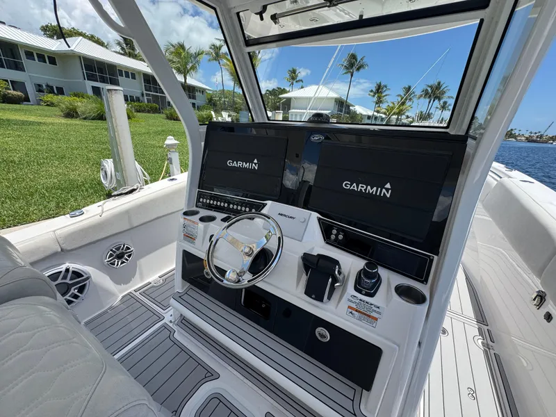 Slide: The Image of 2023 Sea Fox 368 Commander boat with shaded seating area on calm water. - 7