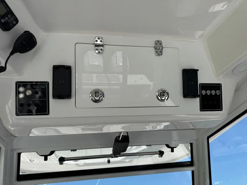 Slide: The Image of 2023 Sea Fox 368 Commander boat interior with seating and table under canopy on water. - 8