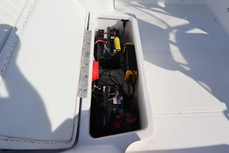 Slide: The Image of 2004 Sea Pro 220 Walk Around boat battery compartment with wiring and components. - 10