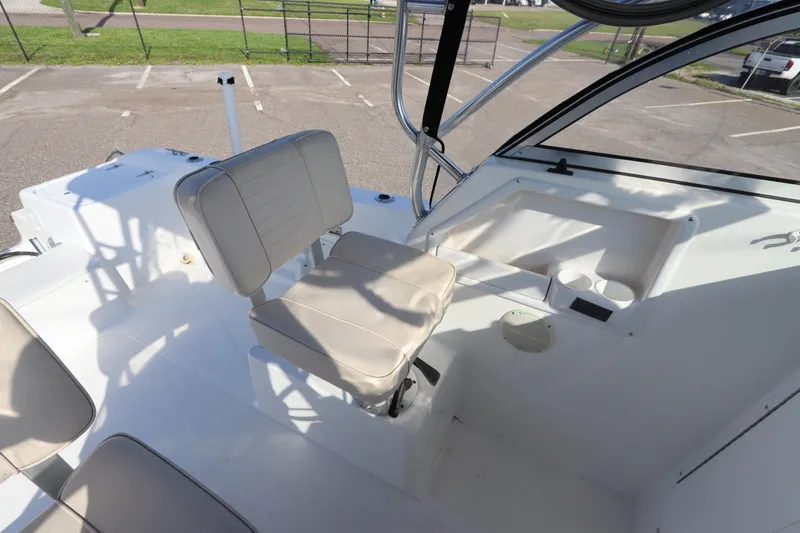 Slide: The Image of 2004 Sea Pro 220 Walk Around boat interior with seating and console. - 18