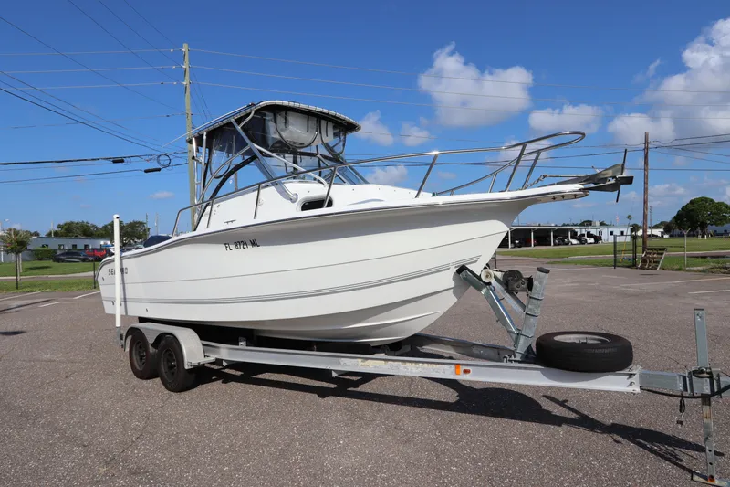Slide: The Image of 2004 Sea Pro 220 Walk Around boat on trailer under clear blue sky. - 2