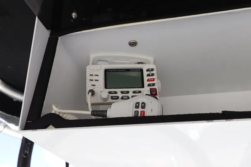 Slide: The Image of 2004 Sea Pro 220 Walk Around boat radio equipment in storage compartment. - 23