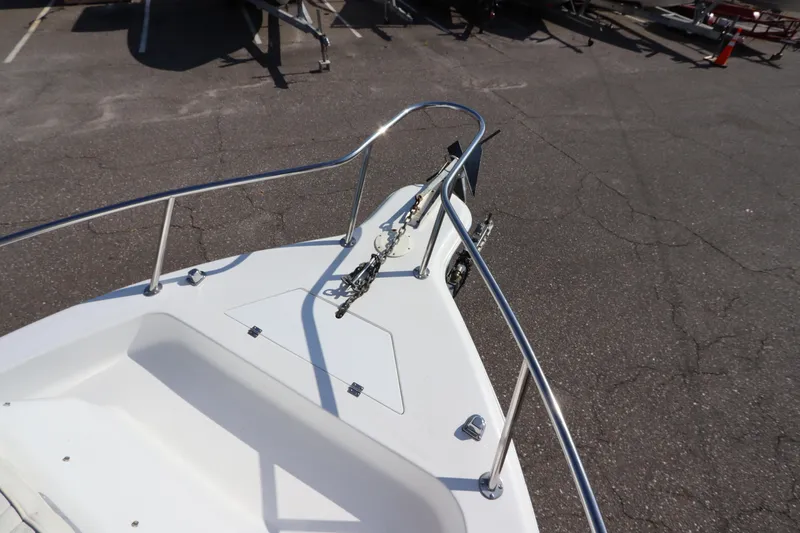 Slide: The Image of 2004 Sea Pro 220 Walk Around boat bow with anchor and railing. - 24