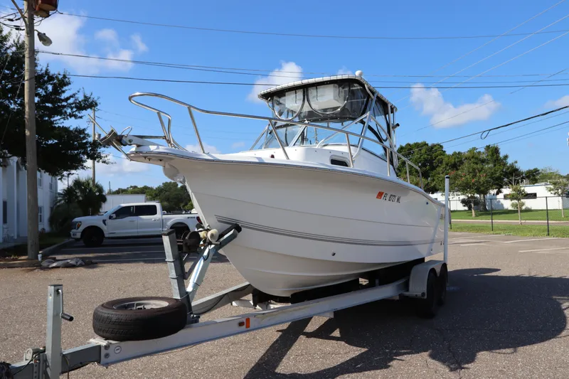Slide: The Image of 2004 Sea Pro 220 Walk Around boat on trailer in parking lot. - 3