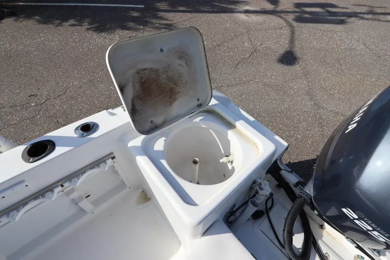 Slide: The Image of 2004 Sea Pro 220 Walk Around boat with open storage compartment and Yamaha engine. - 9