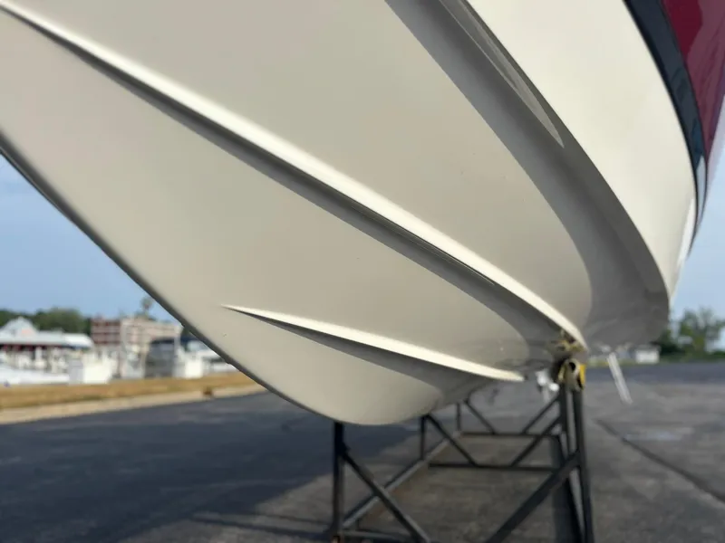 Slide: The Image of 2024 Cobalt R8 Outboard boat hull on display stand, showcasing sleek design. - 14