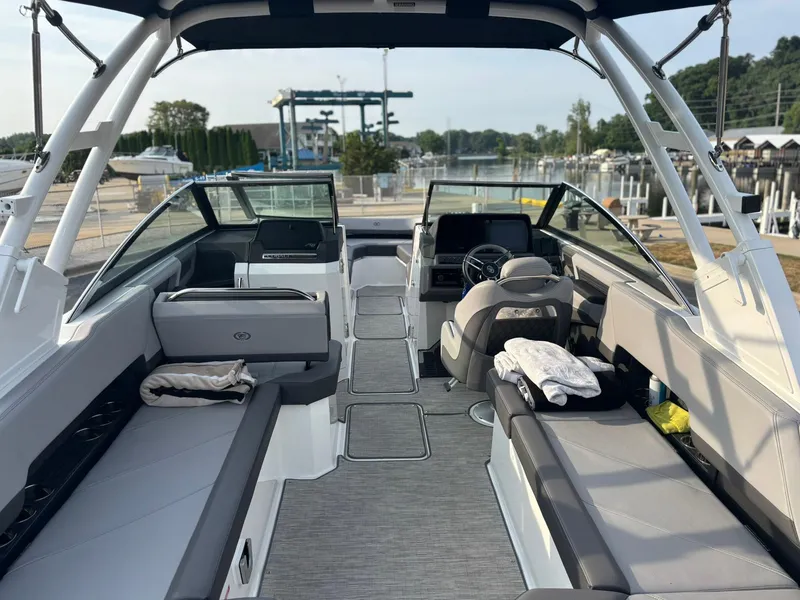 Slide: The Image of 2024 Cobalt R8 Outboard boat interior with seating and helm, docked at marina. - 16