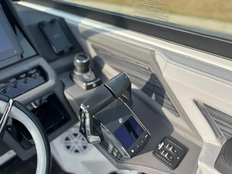 Slide: The Image of 2024 Cobalt R8 Outboard boat dashboard with modern controls and steering wheel. - 28
