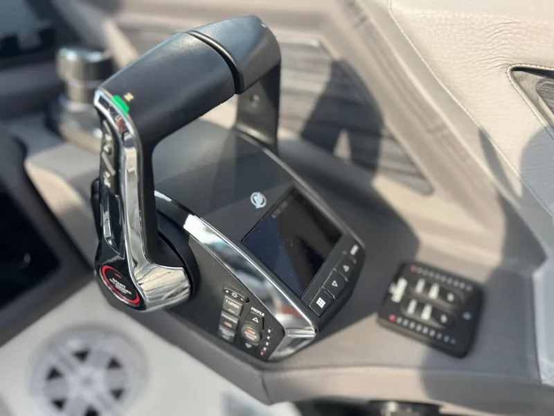 Slide: The Image of Close-up of 2024 Cobalt R8 Outboard boat control panel with throttle and display. - 43