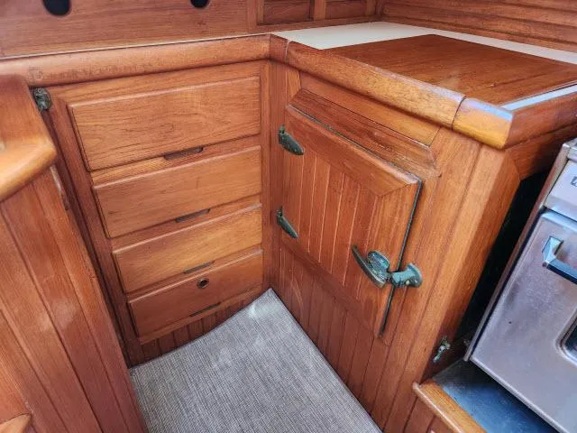 Slide: The Image of 1983 Hans Christian HC33 yacht interior with wooden cabinetry and vintage hardware. - 10