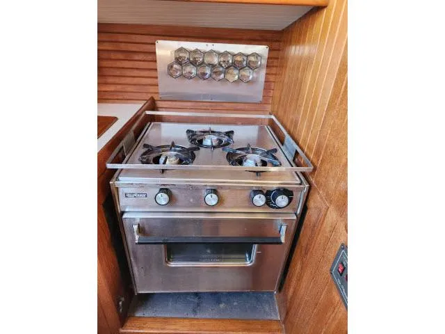 Slide: The Image of Stainless steel stove and oven in a 1983 Hans Christian HC33 boat galley. - 12