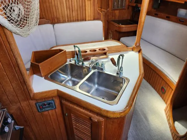 Slide: The Image of Interior of 1983 Hans Christian HC33 sailboat with dual sinks and wooden cabinetry. - 13
