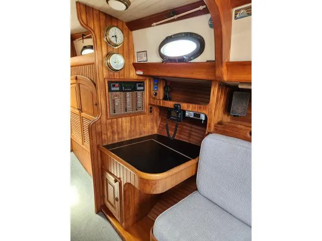 Slide: The Image of 1983 Hans Christian HC33 yacht interior with wooden paneling and navigation instruments. - 14