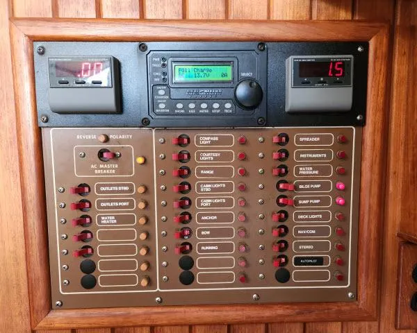 Slide: The Image of Control panel of a 1983 Hans Christian HC33 boat with various switches and displays. - 15