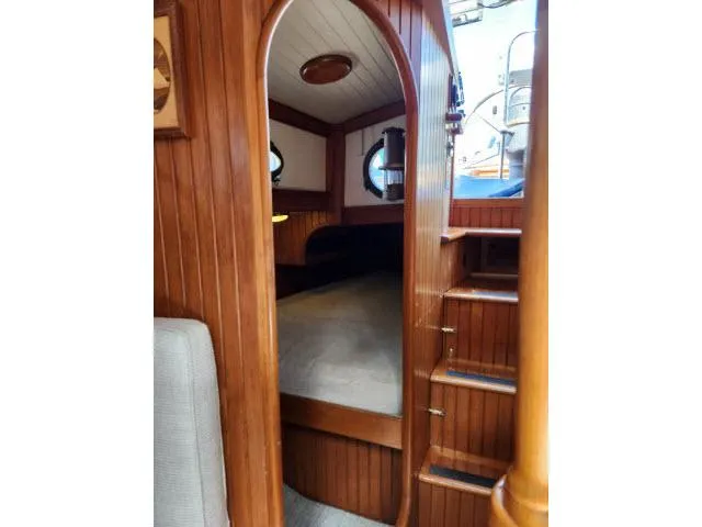 Slide: The Image of 1983 Hans Christian HC33 yacht interior with wooden paneling and cozy cabin space. - 20