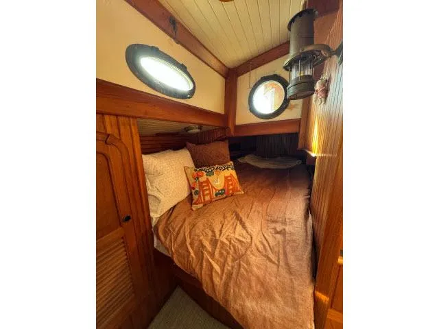 Slide: The Image of Cozy cabin interior of 1983 Hans Christian HC33 sailboat with wooden accents and porthole windows. - 21