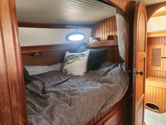 Slide: The Image of Cozy cabin interior of 1983 Hans Christian HC33 sailboat with wooden paneling and bedding. - 25