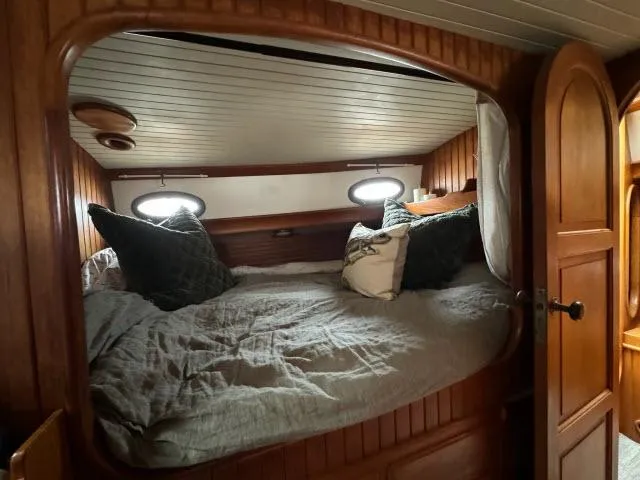 Slide: The Image of Cozy cabin interior of 1983 Hans Christian HC33 sailboat with wooden finish and porthole windows. - 26