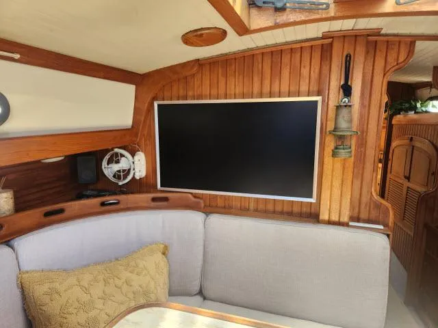 Slide: The Image of Interior of 1983 Hans Christian HC33 sailboat with wood paneling and modern TV. - 3
