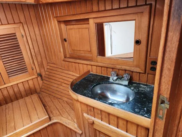 Slide: The Image of 1983 Hans Christian HC33 yacht interior with wooden cabinetry and stainless steel sink. - 30