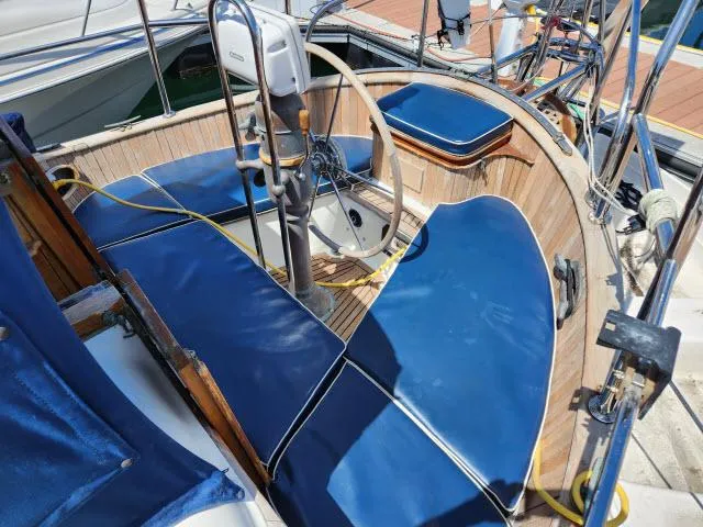 Slide: The Image of 1983 Hans Christian HC33 sailboat cockpit with blue cushions and wooden accents. - 31