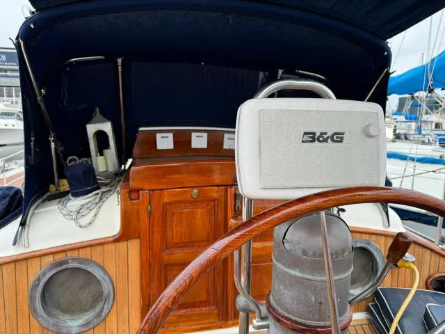 Slide: The Image of 1983 Hans Christian HC33 sailboat cockpit with wooden details and B&G navigation equipment. - 32