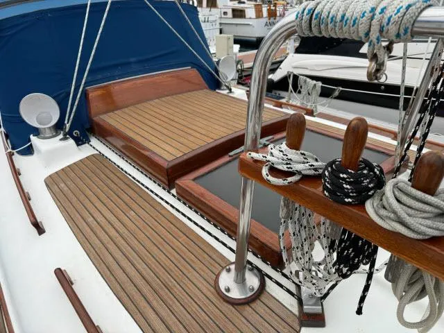Slide: The Image of 1983 Hans Christian HC33 sailboat deck with wood finish and nautical ropes. - 39