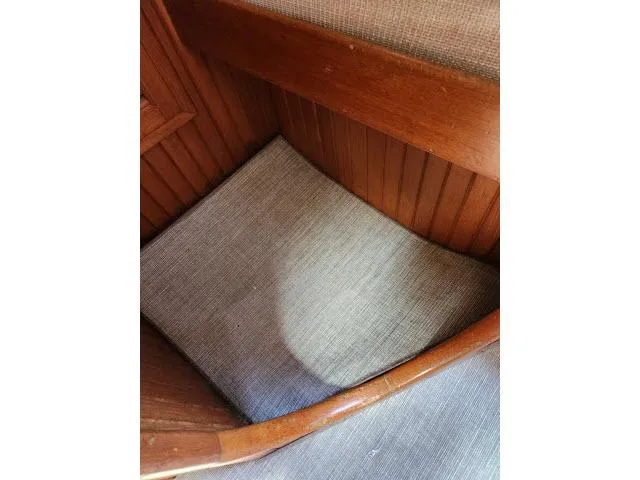 Slide: The Image of Wooden interior detail of a 1983 Hans Christian HC33 boat with cushioned seating. - 48