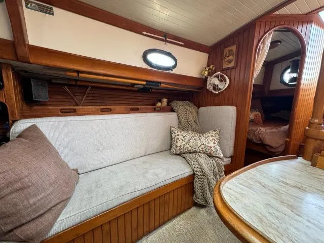 Slide: The Image of Cozy interior of 1983 Hans Christian HC33 sailboat with wooden accents and comfortable seating. - 5