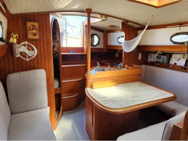 Slide: The Image of Interior of 1983 Hans Christian HC33 sailboat with wooden furnishings and cozy seating area. - 6