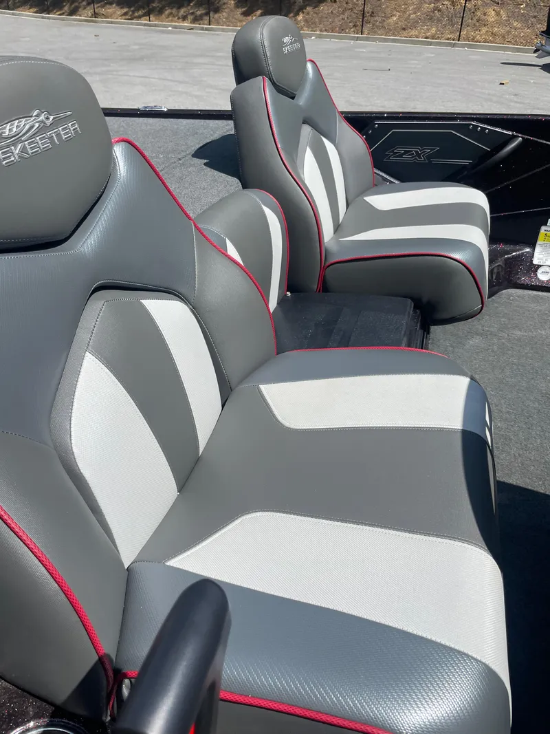 Slide: The Image of 2020 Skeeter ZX 225 boat seats with gray and white upholstery, red accents. - 13