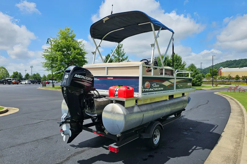 Slide: The Image of 2019 Sun Tracker Bass Buggy 16 DLX pontoon boat with Mercury outboard motor in parking lot. - 10