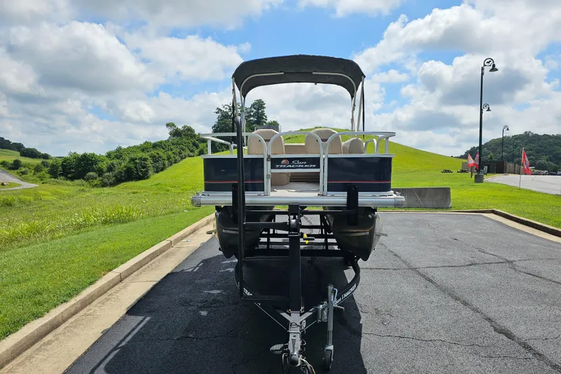 Slide: The Image of 2019 Sun Tracker Bass Buggy 16 DLX pontoon boat on trailer, parked on a sunny day. - 11