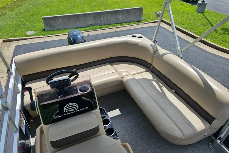 Slide: The Image of 2019 Sun Tracker Bass Buggy 16 DLX pontoon boat with beige seating and steering console. - 3