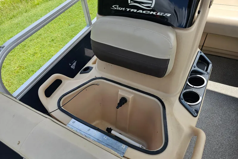 Slide: The Image of 2019 Sun Tracker Bass Buggy 16 DLX interior with storage compartment and cup holders. - 7