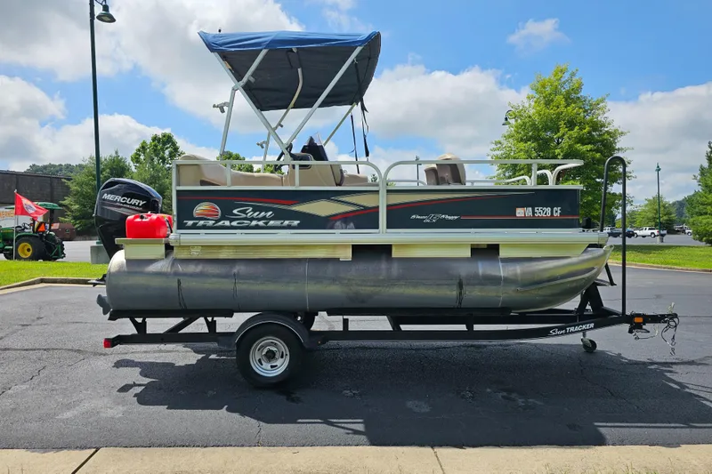 Slide: The Image of 2019 Sun Tracker Bass Buggy 16 DLX pontoon boat on trailer, parked outdoors. - 8
