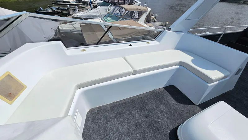 Slide: The Image of 1993 Skipperliner 47 SL boat with white seating area and river view. - 12