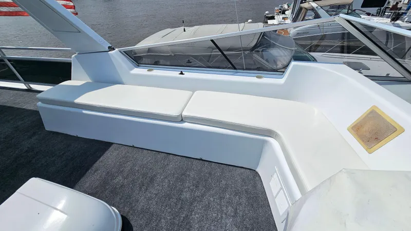 Slide: The Image of 1993 Skipperliner 47 SL boat with white seating and glass panels on deck. - 13