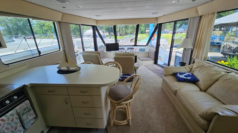 Slide: The Image of Interior of a 1993 Skipperliner 47 SL houseboat with cozy seating and panoramic windows. - 17