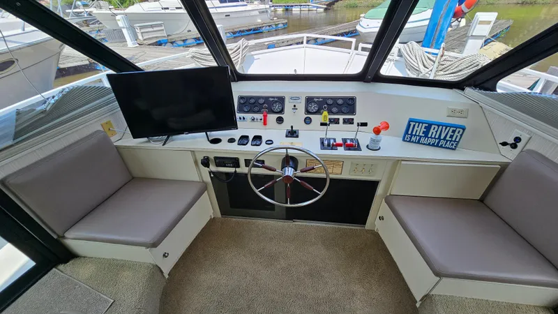 Slide: The Image of 1993 Skipperliner 47 SL boat helm with steering wheel, controls, and seating. - 19