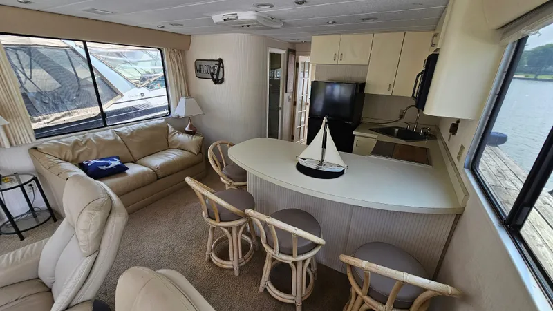 Slide: The Image of Interior of 1993 Skipperliner 47 SL houseboat with cozy seating and kitchenette. - 21