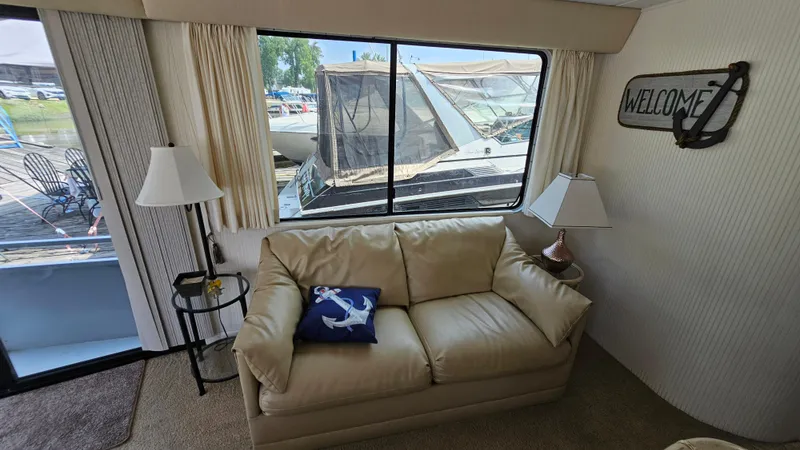 Slide: The Image of Interior of 1993 Skipperliner 47 SL with sofa, nautical pillow, and "Welcome" sign. - 22