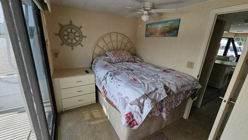 Slide: The Image of Cozy bedroom in 1993 Skipperliner 47 SL houseboat with nautical decor and natural light. - 25