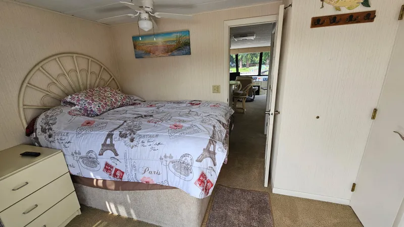 Slide: The Image of Bedroom interior of 1993 Skipperliner 47 SL with Paris-themed bedding and nautical decor. - 27