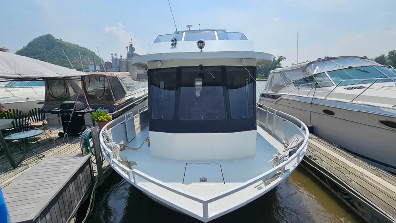 Slide: The Image of 1993 Skipperliner 47 SL boat docked at marina, surrounded by other vessels. - 3