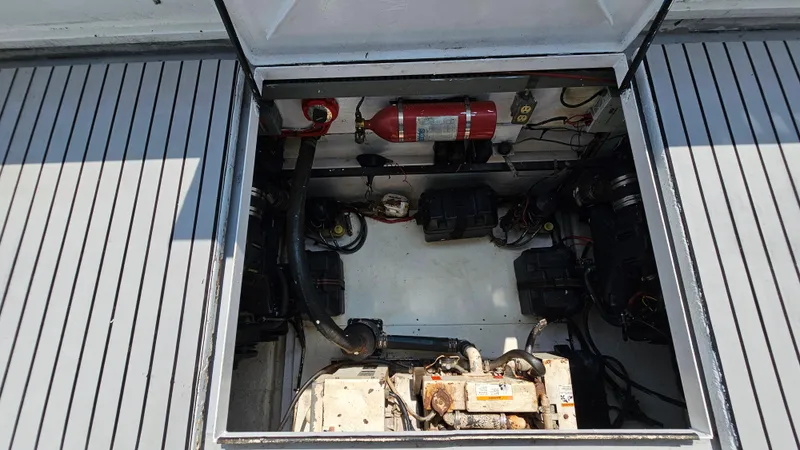 Slide: The Image of Engine compartment of a 1993 Skipperliner 47 SL boat, showing mechanical components and wiring. - 34