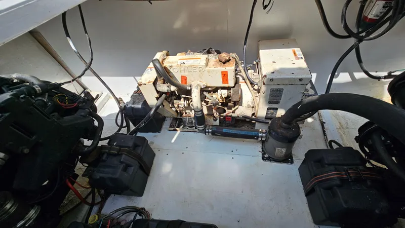 Slide: The Image of Engine compartment of a 1993 Skipperliner 47 SL boat, featuring a Kohler generator. - 38