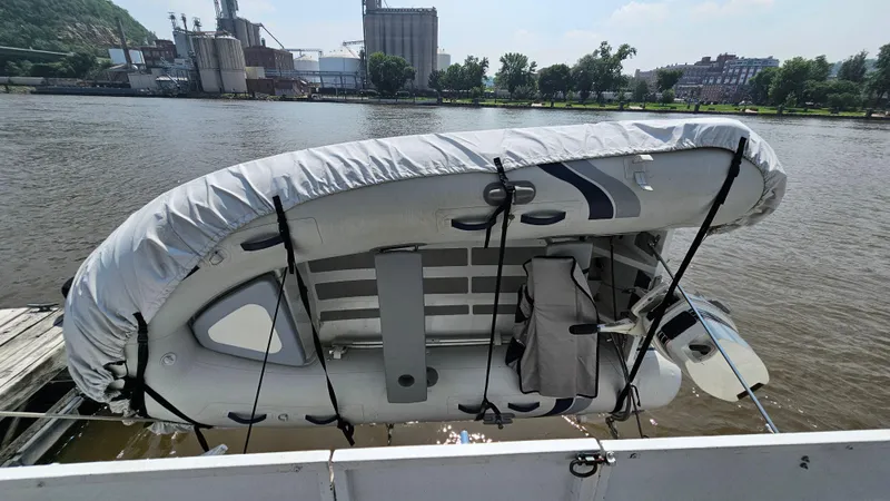 Slide: The Image of Inflatable boat secured on a Skipperliner 47 SL, 1993, docked by an industrial riverside. - 39